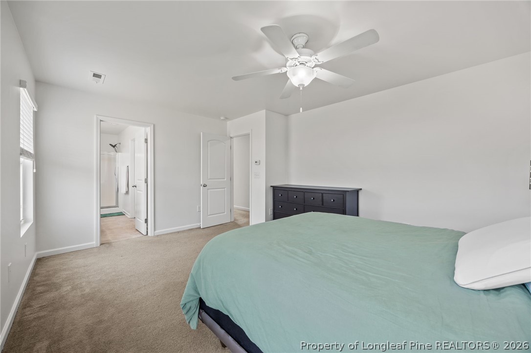 226 River Oak Street Spring Lake, NC 28390 - Photo 24 of 41 a bedroom with a bed and a chandelier