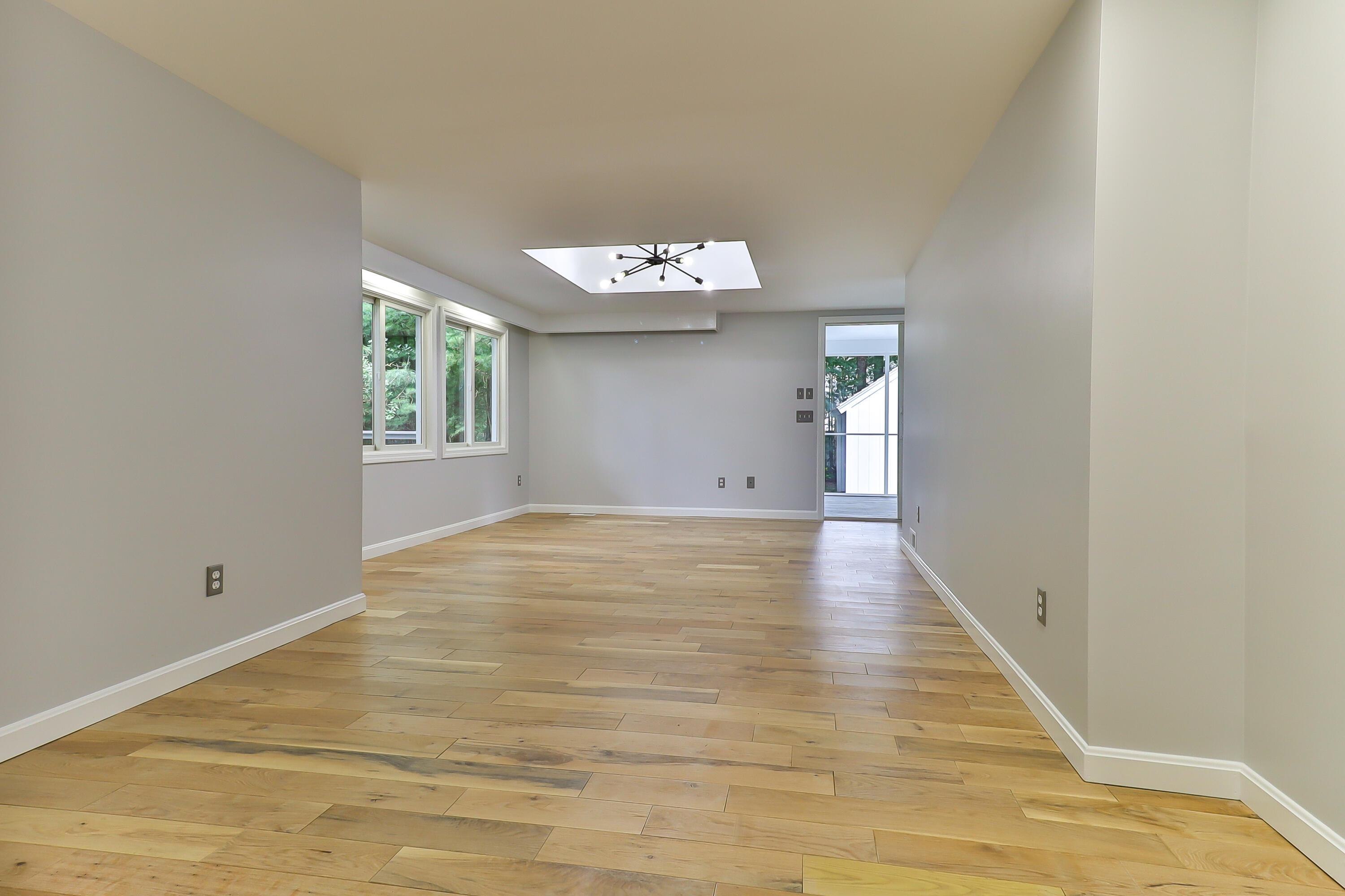 7 Guildford Road Centerville, MA 02632 - Photo 12 of 28 a view of an empty room with wooden floor and a window