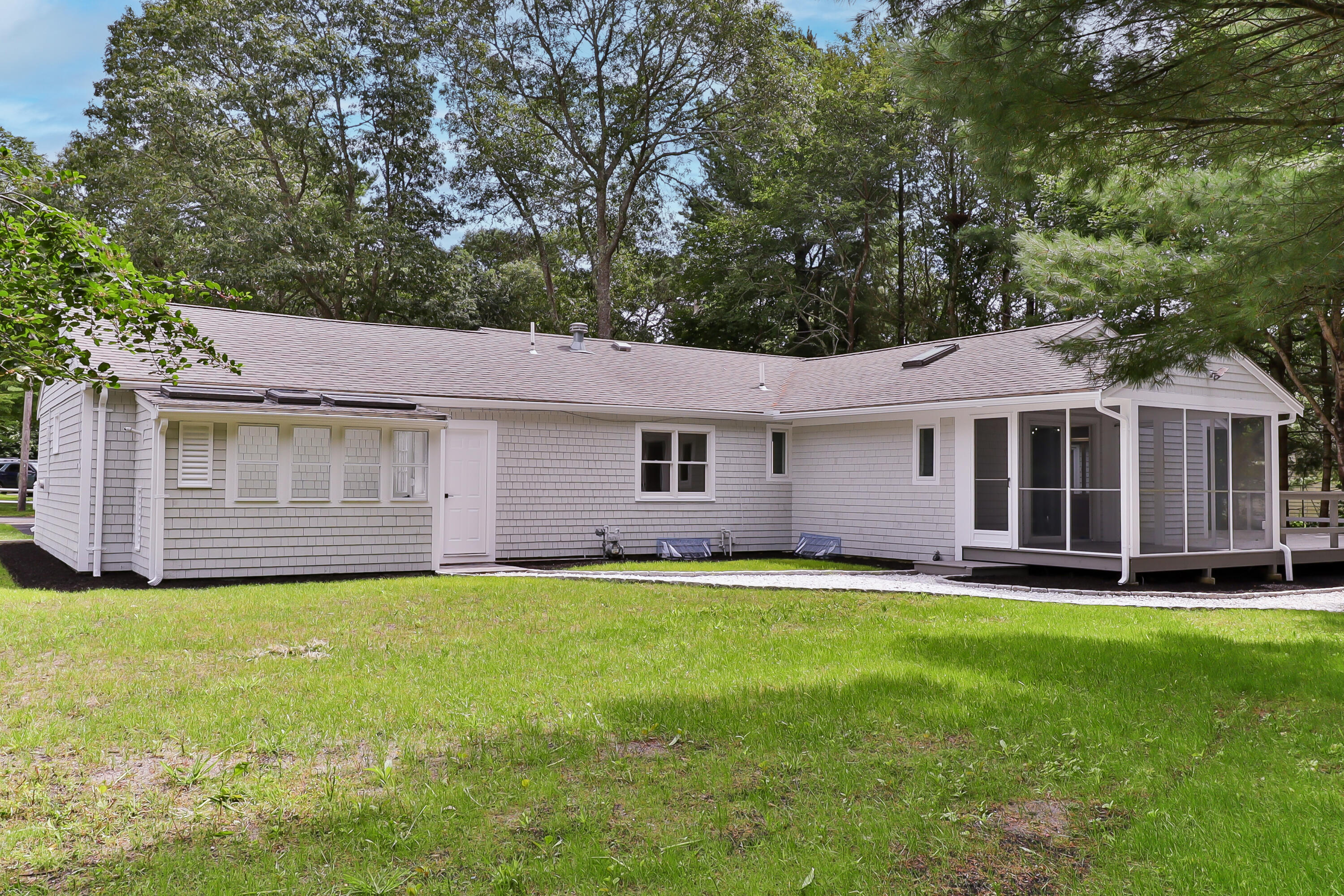 7 Guildford Road Centerville, MA 02632 - Photo 27 of 28 a front view of a house with a yard and trees