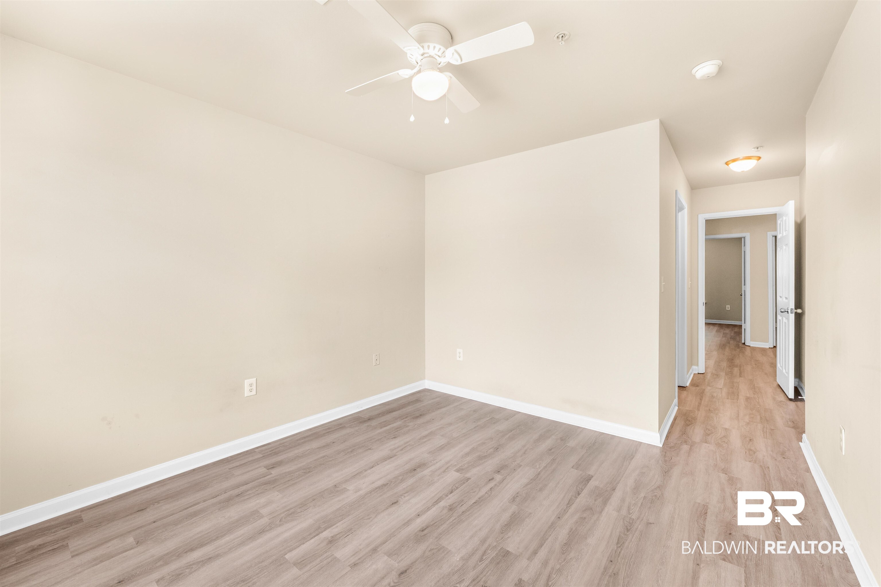 1517 Regency Road, Unit 85 Gulf Shores, AL 36542 - Photo 18 of 32 Empty room featuring ceiling fan and light hardwood / wood-style floors