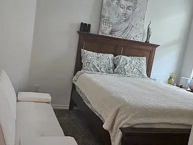 a large bed sitting in a bedroom next to a wall
