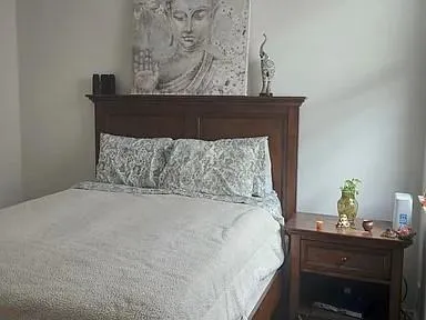 a bed sitting in a bedroom next to a window