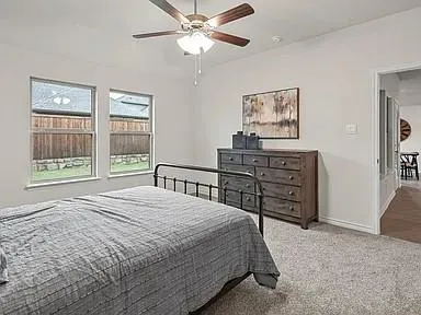 a bedroom with a bed dresser and a window