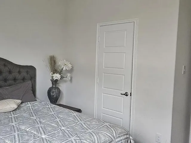 a bedroom with a bed and a table