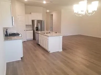 a kitchen with stainless steel appliances a sink stove and refrigerator