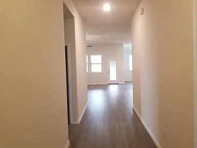 a view of hallway with wooden floor