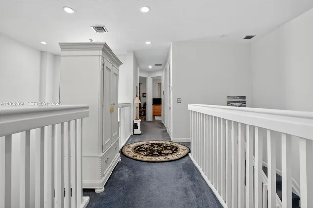 a view of a hallway and dining room with wooden floor