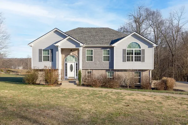 a front view of a house with a yard