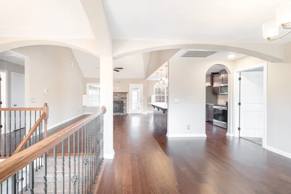 a view of a hallway view with wooden floor and staircase