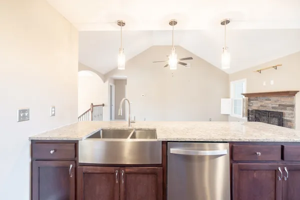 a kitchen with a sink a counter space and cabinets