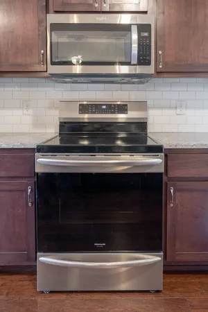 a stove top oven sitting inside of a kitchen