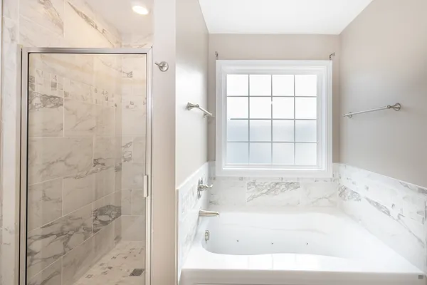 a white bath tub sitting next to a window