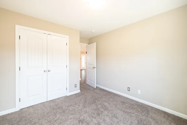 a view of an empty room with a ceiling fan