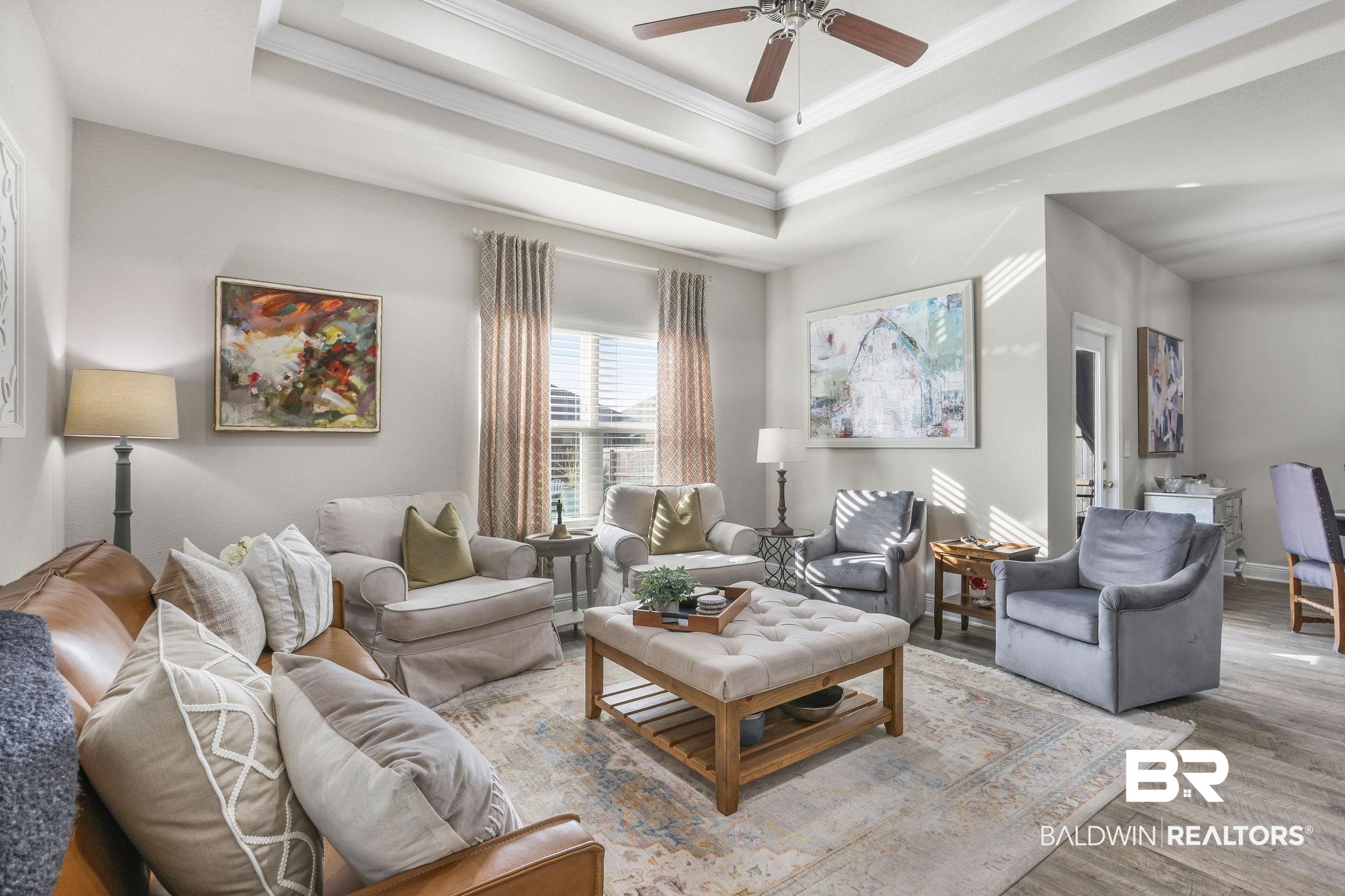 9056 Impala Drive Foley, AL 36535 - Photo 6 of 22 Living room featuring a tray ceiling, ornamental molding, light hardwood / wood-style floors, and ceiling fan