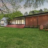 a backyard of a house with wooden floor and fence