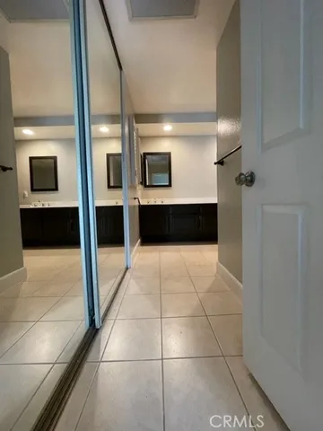 a bathroom with a tub a mirror and a shower