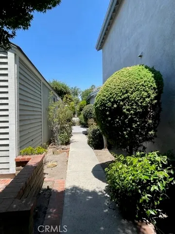 a view of a hallway with wooden floor and stairs