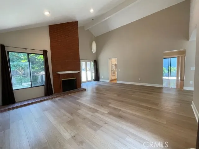 a view of kitchen with stainless steel appliances granite countertop a stove a sink and a refrigerator
