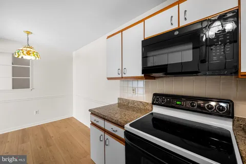 a kitchen with a stove and a microwave