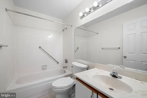 a bathroom with a sink toilet tub and shower