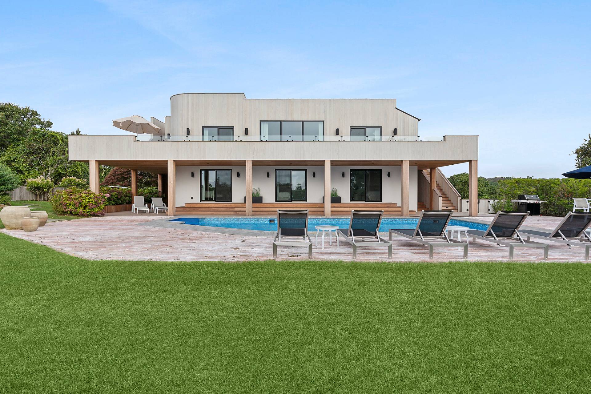 a view of a house with a big yard and sitting area