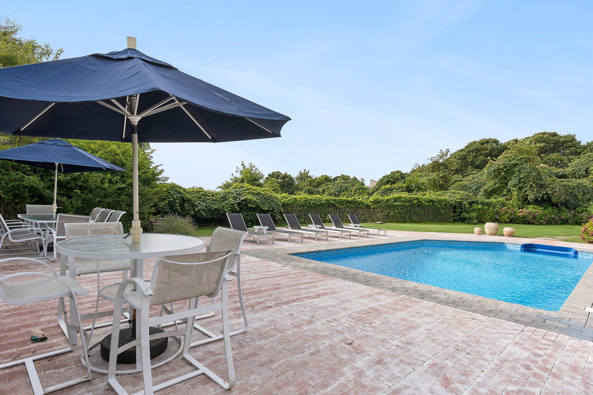 11 Fairview Road Montauk, NY 11954 - Photo 25 of 38 a view of pool with table and chairs under an umbrella