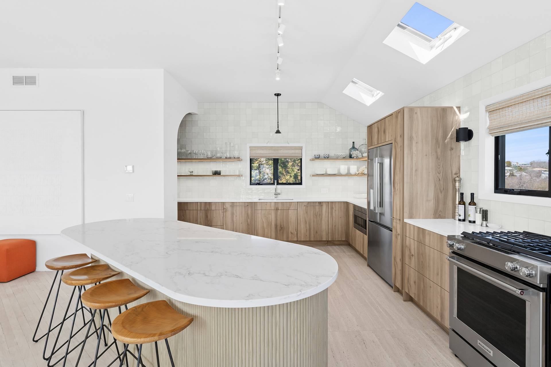 11 Fairview Road Montauk, NY 11954 - Photo 8 of 38 a large kitchen with stainless steel appliances kitchen island granite countertop a table chairs in it and a wooden floor
