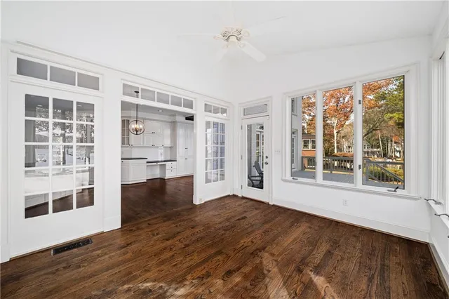 a large kitchen with granite countertop a stove a sink a window and a dining table