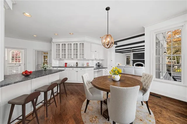 a large kitchen with granite countertop a stove top oven sink and cabinets