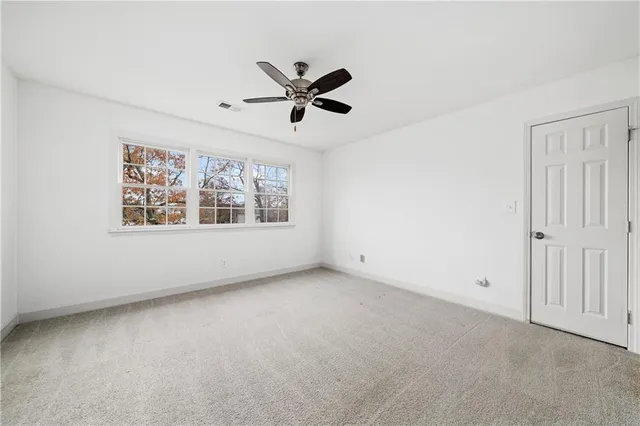 an empty room with a empty space and windows