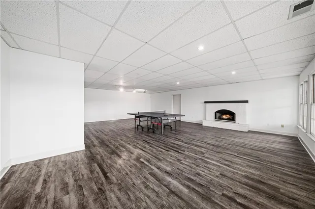 a view of a livingroom with wooden floor and windows