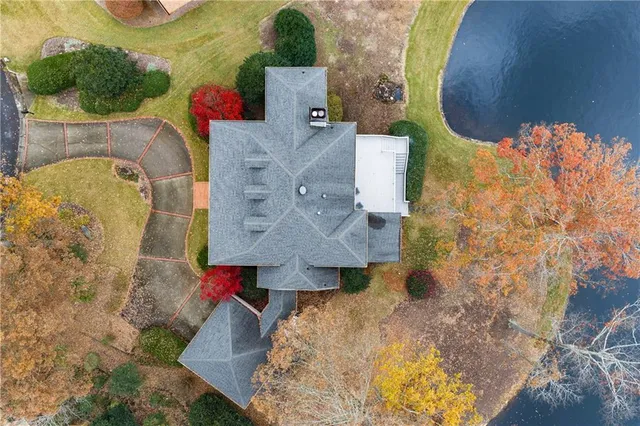 an aerial view of a house with a lake view