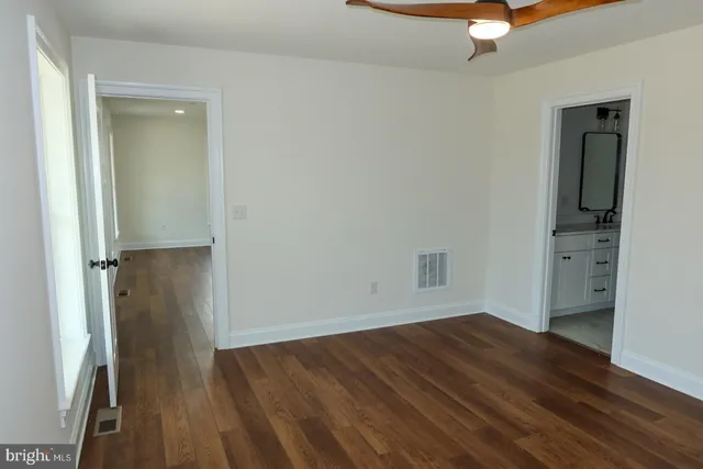 a bathroom with a sink vanity and mirror