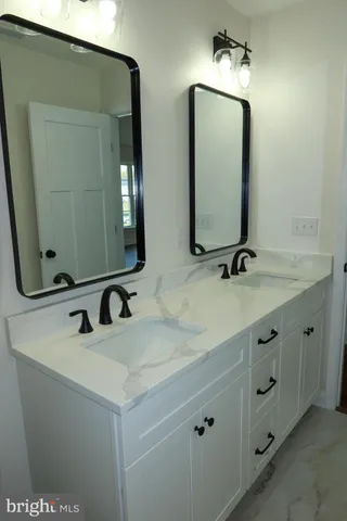 a bathroom with a granite countertop sink and vanity