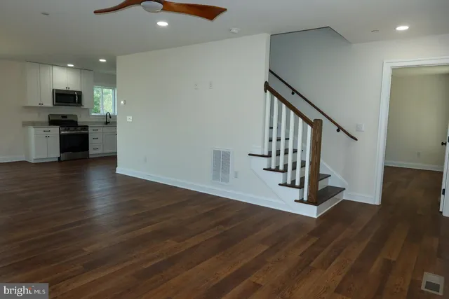 a kitchen with stainless steel appliances granite countertop a refrigerator a stove and a sink