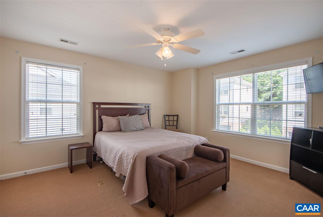335 Quarry Road Charlottesville, VA 22902 - Photo 21 of 36 a bedroom with a bed and a chandelier