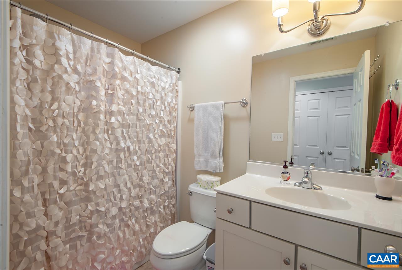 335 Quarry Road Charlottesville, VA 22902 - Photo 24 of 36 a bathroom with a sink a toilet and shower curtain