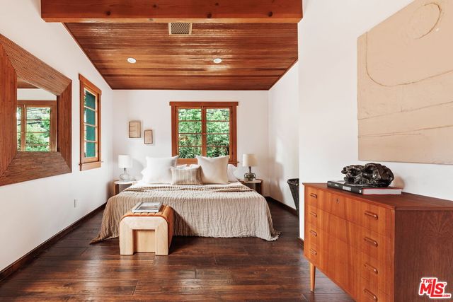 a bedroom with furniture and wooden floor