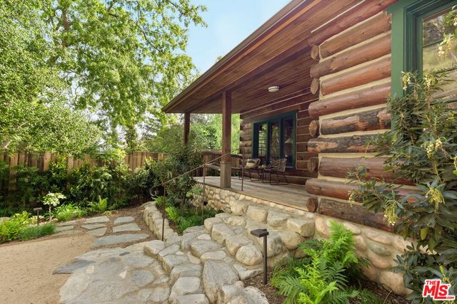 a view of a patio with couple of chairs
