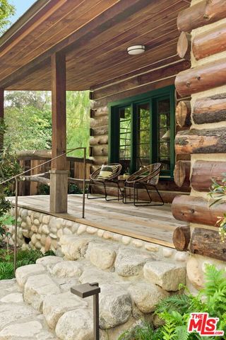 a view of patio with couches and a fire pit