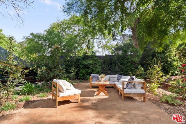 a view of a small house in the middle of a yard
