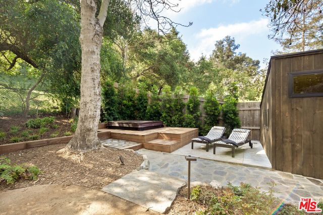 a backyard of a house with barbeque oven table and chairs
