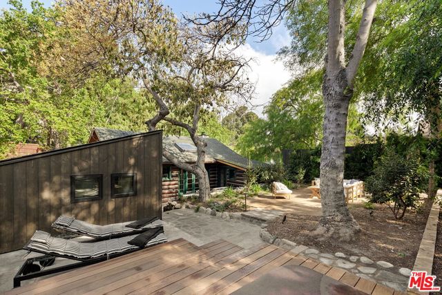 a backyard of a house with table and chairs