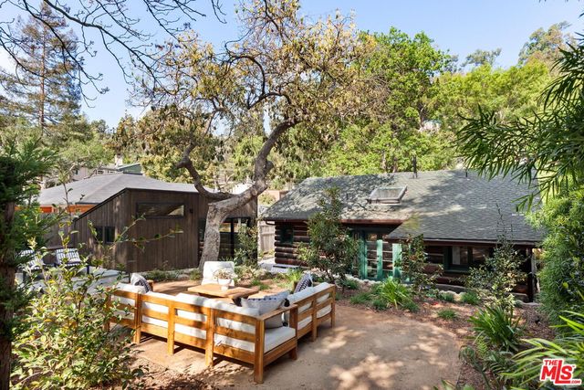a backyard of a house with table and chairs