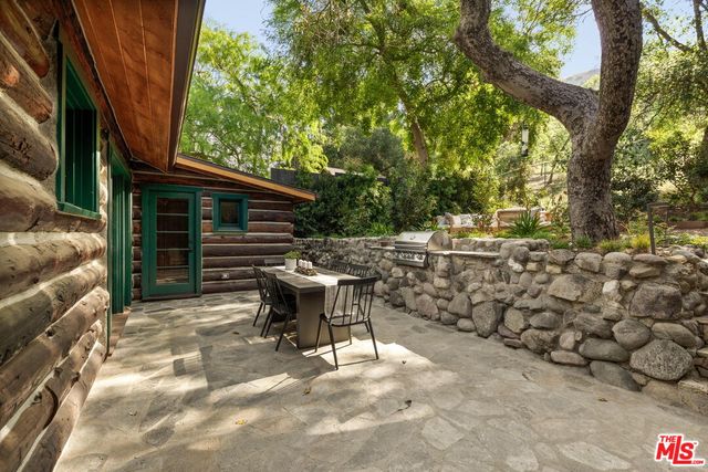 a view of a house with a yard and tree s