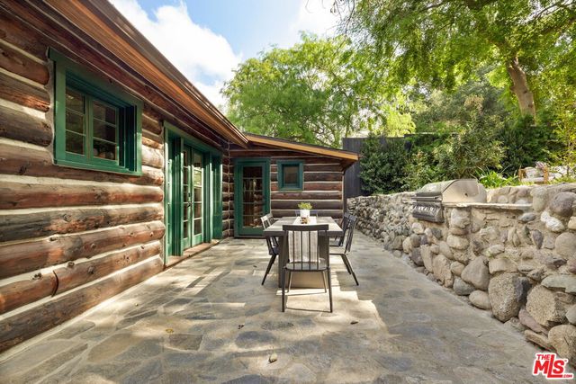 a backyard of a house with table and chairs