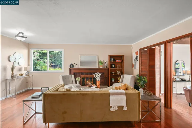 a living room with furniture a window and a fireplace