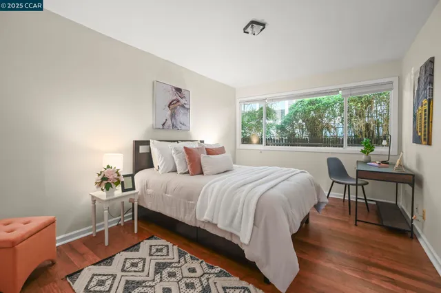 a bedroom with a bed and a large window