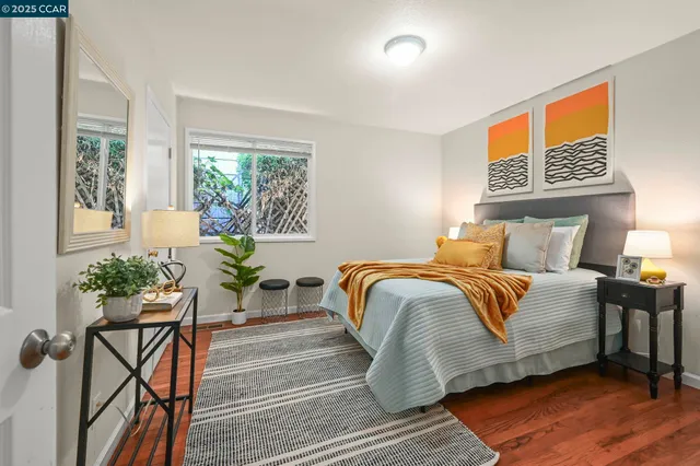 a bedroom with a bed and windows