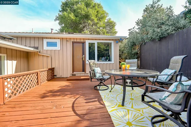 a view of a patio with a table and chairs